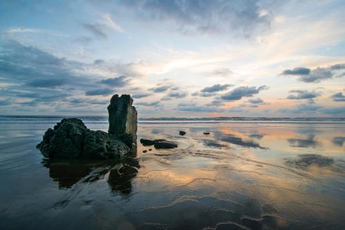 a rock in the middle of a body of water at The Humpback Turtle in El Valle