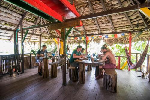 a group of people sitting at tables in a restaurant at The Humpback Turtle in El Valle