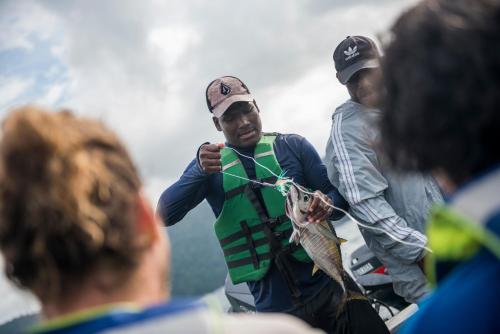 two men are holding a fish on a rope at The Humpback Turtle in El Valle