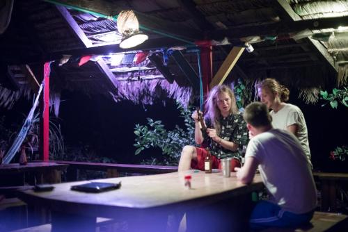 a group of people sitting at a table in a bar at The Humpback Turtle in El Valle
