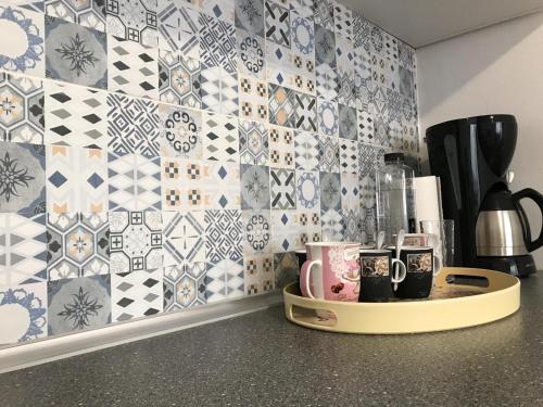 a kitchen with blue and white tiles on the wall at Central View Apartment in Timişoara