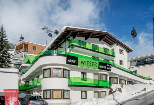 a white and green building with a sign on it at Apart Hotel Garni Wieser in Sölden