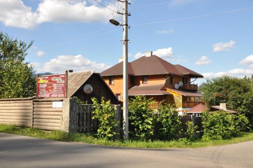 a house with a sign in front of it at Садиба "ЯНА" in Slavske