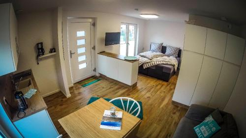 a living room with a bed and a table at WeststrandPur in Norderney