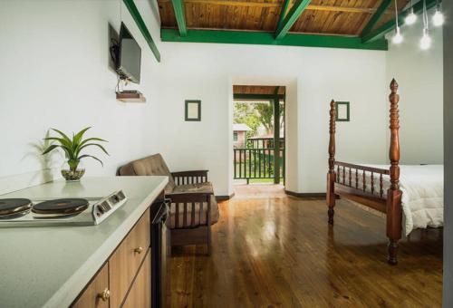 a kitchen with a stove and a bed in a room at Hacienda Juanita in Maricao