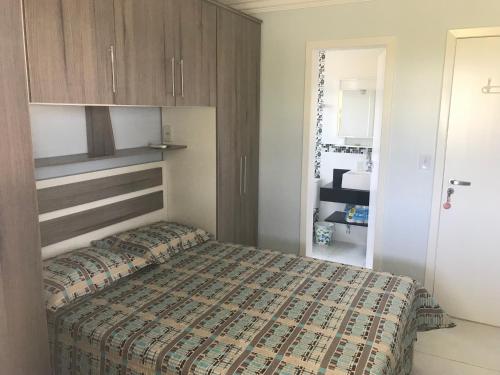 a bedroom with a large bed in a room at Casa do Saí in Guaratuba