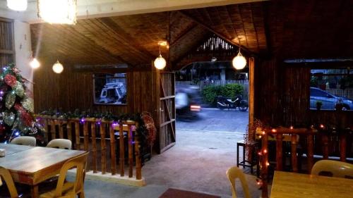 a dining room with a christmas tree and a table at Villa Peralta Inn in Donsol
