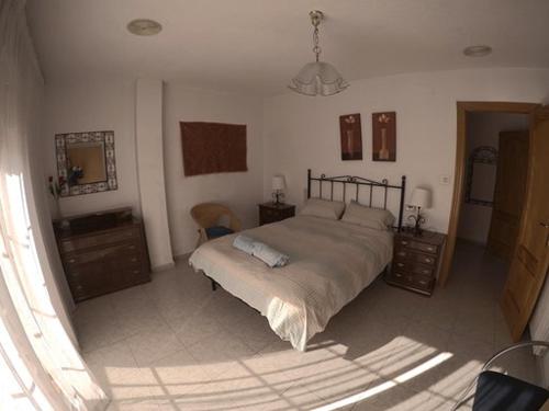 a bedroom with a large bed and a mirror at Casa Ghalia in Cenes de la Vega