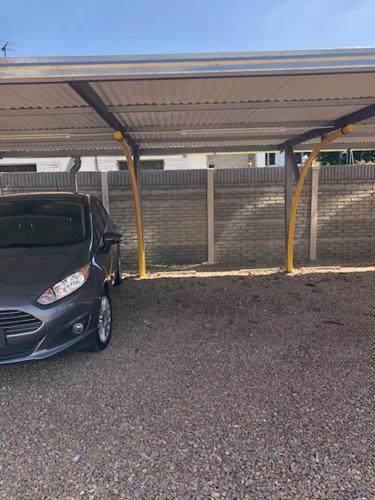 a small car parked under a parking lot at Lugones in Ezeiza