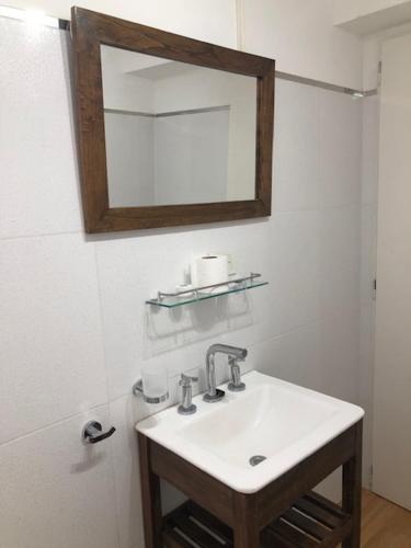 a bathroom with a sink and a mirror at Lugones in Ezeiza