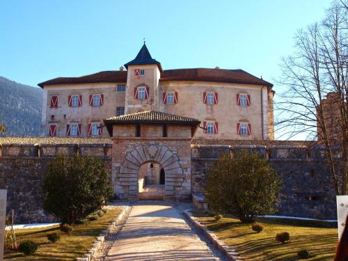 a large stone building with a tower on top at Casa vacanze Dos de Loré - Relax a due passi da Tovel in Tuenno