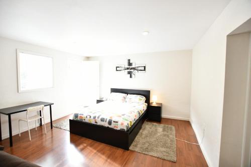 a bedroom with a bed and a table and a window at Private Unit / Private Bathroom Near BART & SF in Daly City
