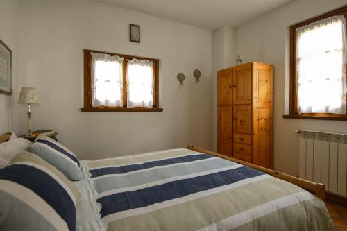 Un pat sau paturi într-o cameră la Baita de Eliseo B&B