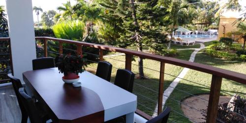 a white table with a vase on a balcony at Villa Victoria in Sosúa