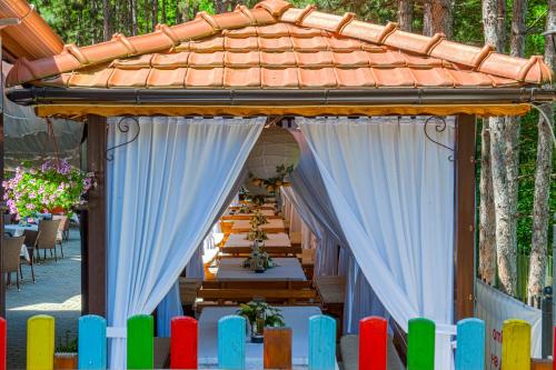 a set up for a wedding under a gazebo at Hotel Park Bachinovo in Blagoevgrad