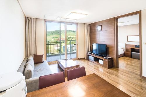 a living room with a couch and a television at Sono Belle Cheonan in Cheonan