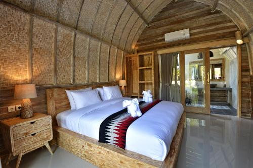 Ліжко або ліжка в номері Kompyang Cottage