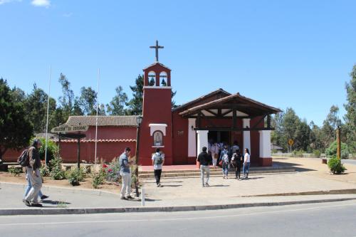a group of people standing outside of a church at El Rincon de Las Pleyades in El Quisco