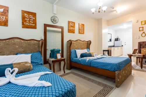 a bedroom with two beds and a mirror at Home Of Soleil in Tagaytay