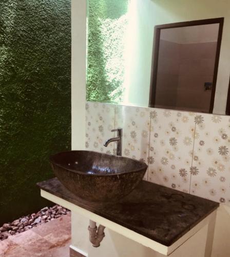 a bathroom with a sink and a mirror at Lembongan Hostel in Nusa Lembongan