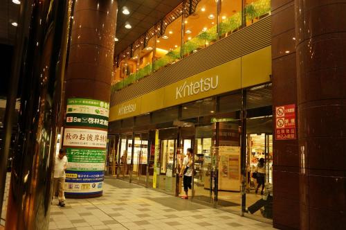 a shopping mall with people walking inside of it at Atelier Bee's Knees Bed & Breakfast in Ikuma