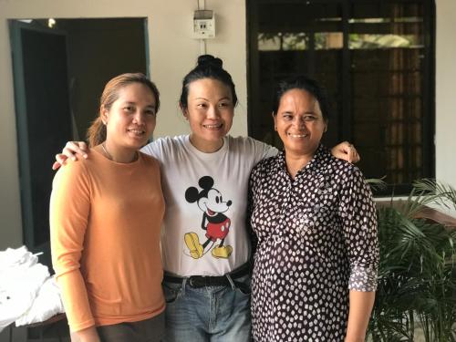 a group of three women standing next to each other at Madam Sokha Homesteading in Siem Reap