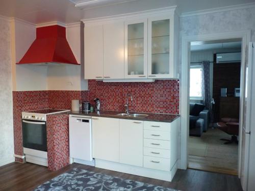a kitchen with white cabinets and a red at Holiday home Hammarstrand 4 persons in Hammarstrand