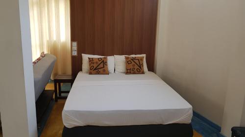 a bedroom with a bed with white sheets and pillows at Be Relaxing @ NO. 1 Galle City in Galle