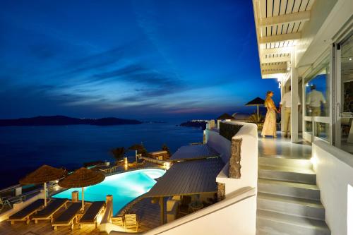 a view of the ocean from the balcony of a hotel at Santorini Princess Spa Hotel in Imerovigli