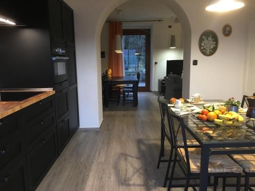 a kitchen and dining room with a table with fruit on it at Baita Sorriso in Brunate