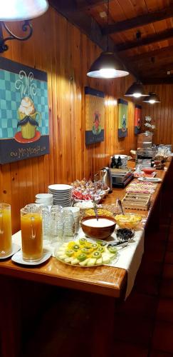 a buffet line with food and drinks in a restaurant at Hotel Sulayr in Sierra Nevada