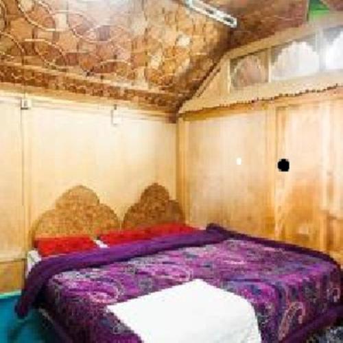 a bedroom with a purple bed in a room at S Group Of Houseboat in Srinagar