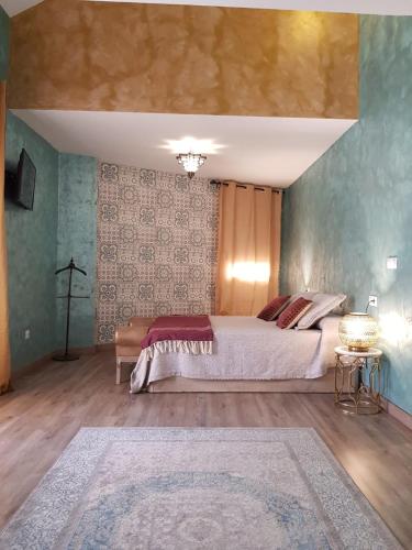 a bedroom with a large bed and a rug at Riad Medina Mudejar in Toledo