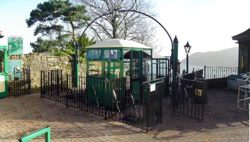 a playground with a gate and a play structure at Lee House in Lynton