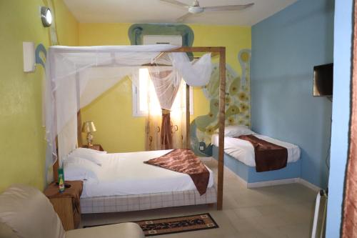 a bedroom with two bunk beds and a mirror at Africa 6 Plage in Somone