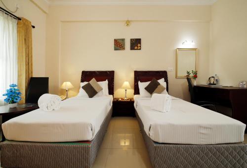 Katil atau katil-katil dalam bilik di Rose International Hotel