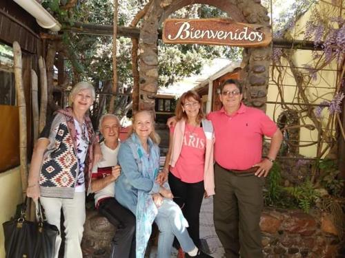 a group of people posing for a picture under a sign at Don Romulo in Tupungato