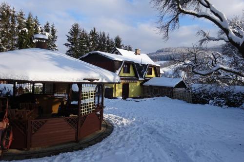 a gazebo with snow on top of it at Apartmány Modus 2 in Česká Ves