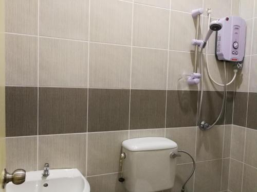 a bathroom with a shower and a toilet and a sink at Address No 915, Lorong Uni Central 13, Taman Uni Central, Kuching Samarahan Expressway in Kuching