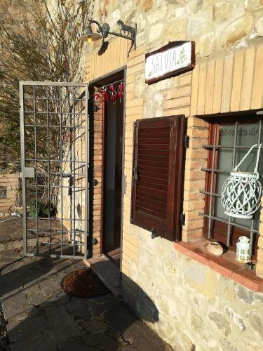 a building with a door and a sign on it at La Locanda Dell'olmo in Orvieto