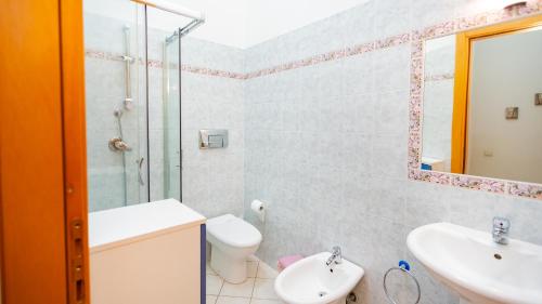 a bathroom with a toilet sink and a shower at Casa Lua in Villasimius