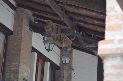 a light hanging from the ceiling of a building at Agriturismo Cipolli e Podò Corte Carlini in Mantova