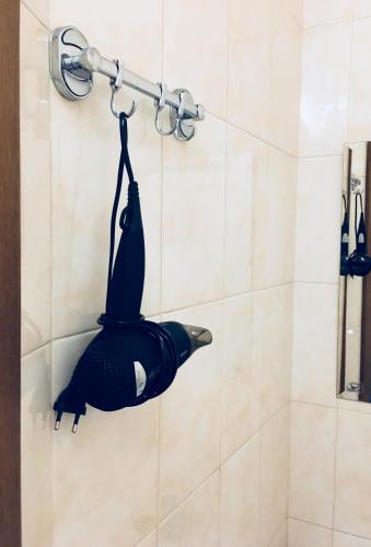 a person is hanging on a shower rack at Апартаменти готельного типу in Lviv