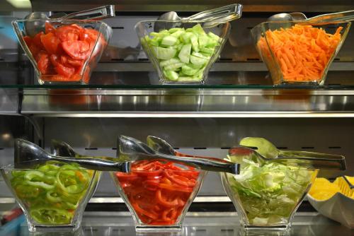 a display of different types of vegetables in glass bowls at Rosslyn Central Park Hotel Sofia in Sofia