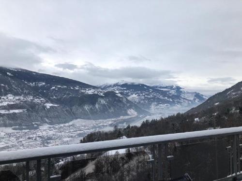 a view of a valley in the mountains with snow at Appartement d'hôtes An Kaz La in Crans-Montana