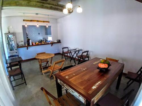 a dining room with a wooden table and chairs at Refúgio 755 in Florianópolis