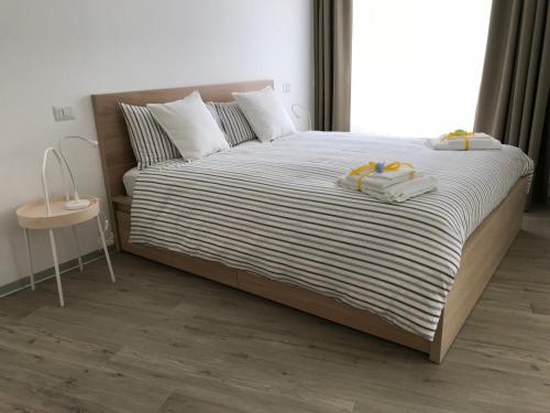 a bedroom with a bed with two towels on it at A Matera "Sotto i pini" in Matera