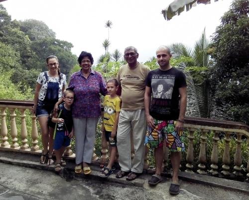 a family posing for a picture on a bridge at Evergreen in Kandy