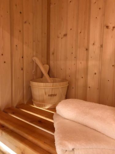 a sauna with a bucket and a paddle in it at Family & Business Sauna Apartments Sienkiewicza No1 Centrum Plac Lliteratów- Piękny Apartament - 1 Bedroom with Private Sauna, Bath with Hydromassage, Parking in Kielce