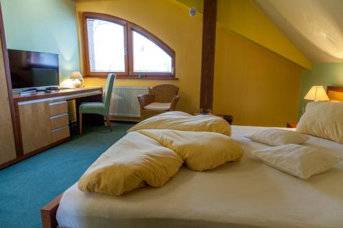 a bedroom with two beds with pillows on it at Penzion u Pejtrika in Mengusovce